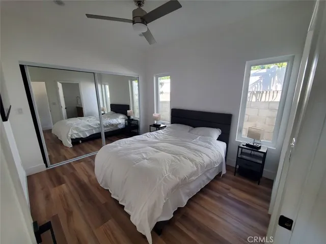 a bedroom with double bed and windows