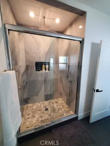 a bathroom with a shower and a sink