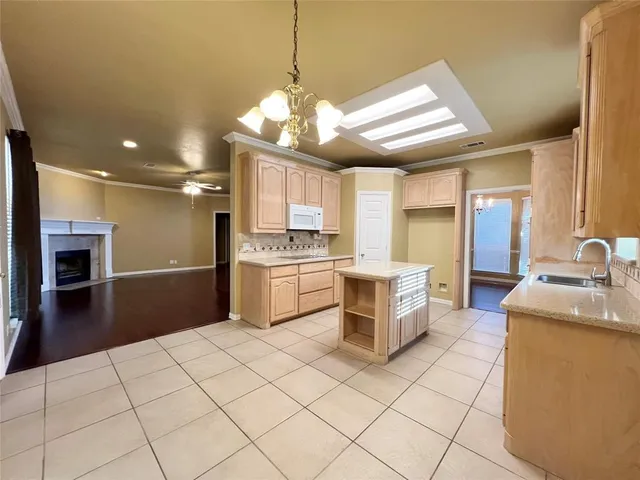 a kitchen with a stove a sink and a refrigerator
