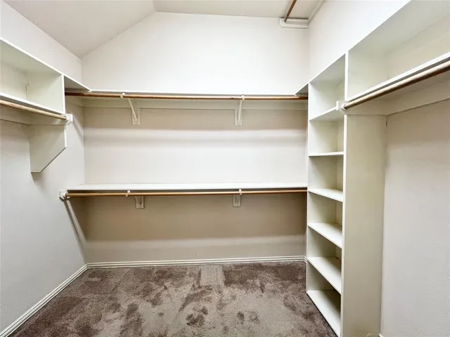 an empty room with a empty space and windows