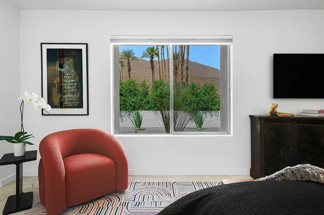 a view of a garden with mountains in the background