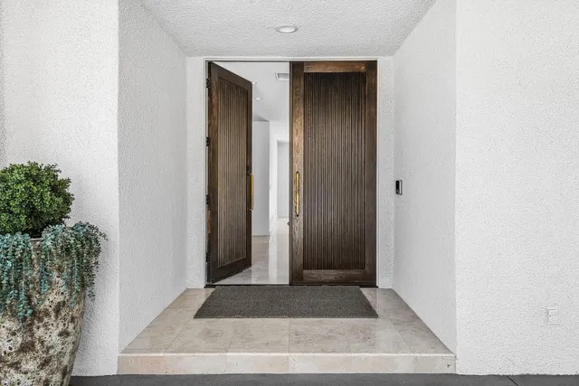 a living room with furniture and a floor to ceiling window