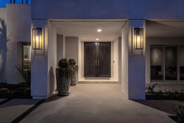 a view of a living room with furniture and chandelier
