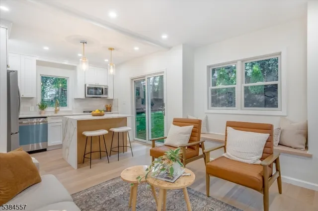 a living room with furniture a large window and a table
