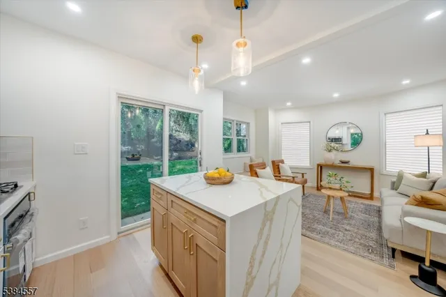 a kitchen with stainless steel appliances granite countertop a stove and a refrigerator