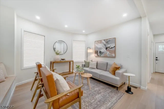 a living room with furniture a rug and a window