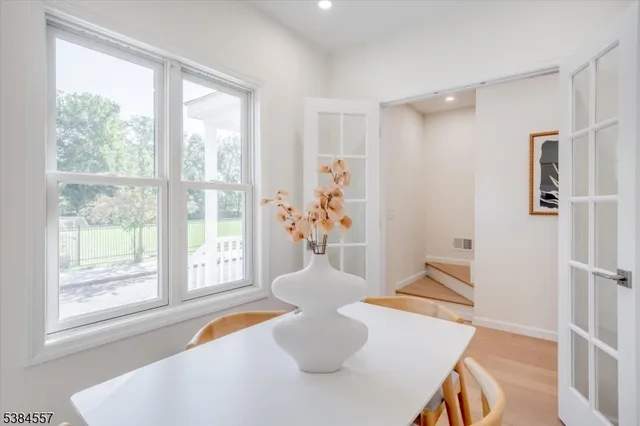 a dining room with furniture and wooden floor