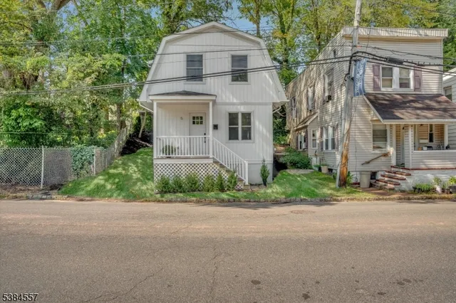 a front view of a house with a yard and a garage