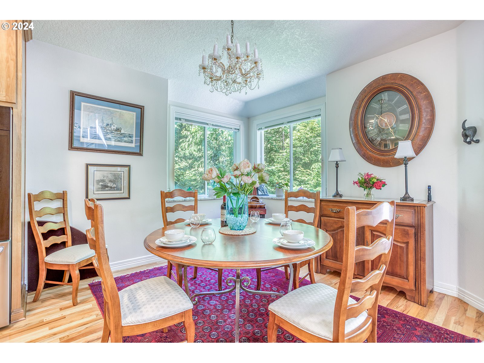 115 Southwest Cormorant Depoe Bay, OR 97341 - Photo 22 of 47 a view of a dining room with furniture a chandelier and wooden floor