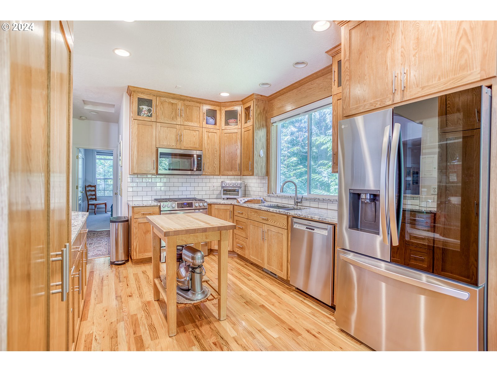 115 Southwest Cormorant Depoe Bay, OR 97341 - Photo 24 of 47 a open kitchen with stainless steel appliances granite countertop a refrigerator a stove and a sink with large window