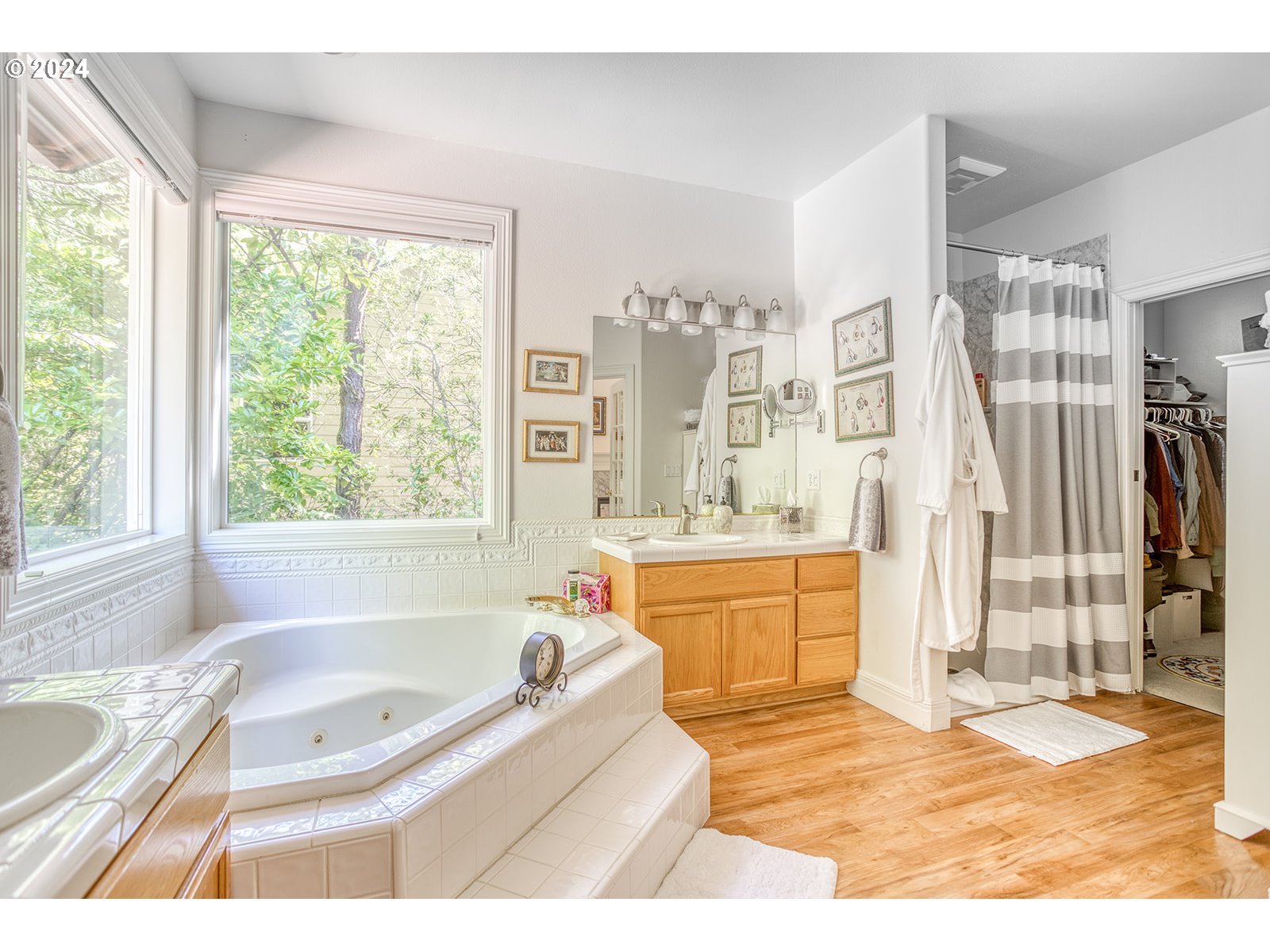 115 Southwest Cormorant Depoe Bay, OR 97341 - Photo 33 of 47 a bathroom with a granite countertop tub a sink a mirror and a bathtub