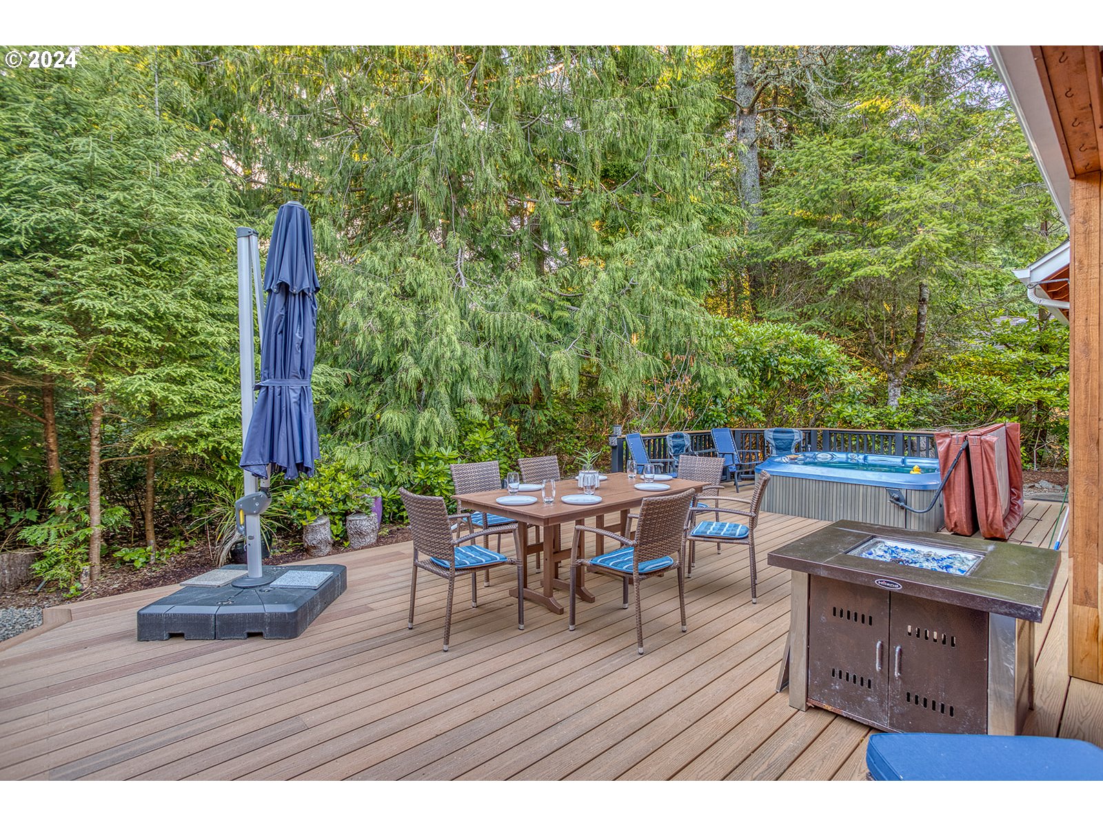 115 Southwest Cormorant Depoe Bay, OR 97341 - Photo 9 of 47 a view of a patio with a dining table and chairs with wooden floor