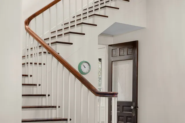 a view of a hallway with wooden floor and entryway