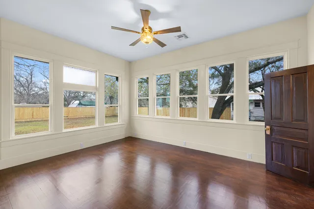 a view of a hallway with wooden floor and entryway