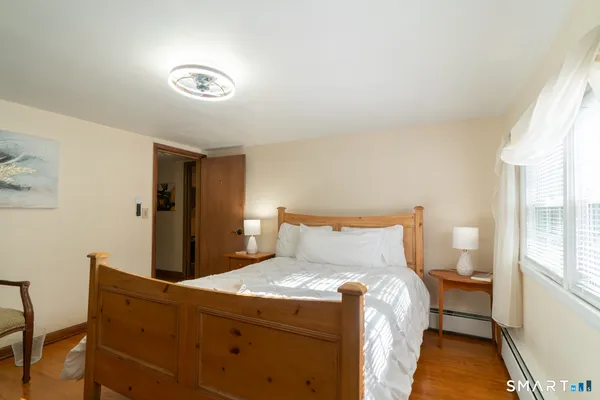 a bed sitting in a bedroom next to a window
