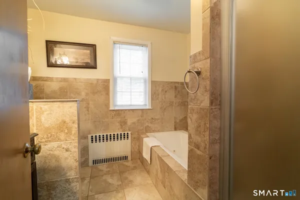 a bathroom with a tub and a shower