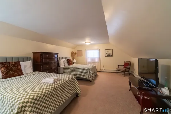 a bedroom with double bed and a flat screen tv