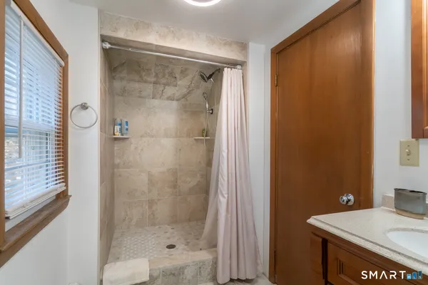 a bathroom with a shower and a sink
