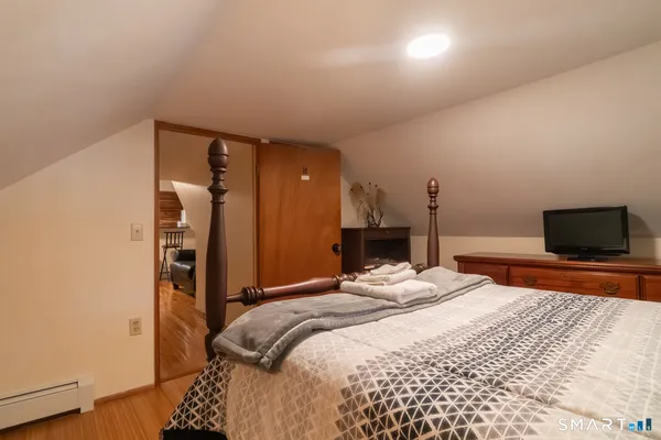 a bedroom with a bed and a flat screen tv