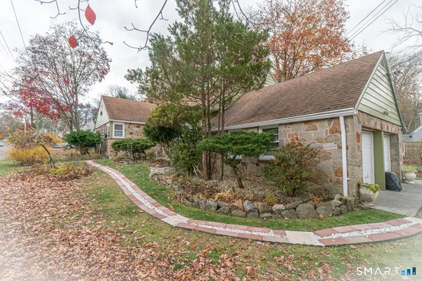 a view of a house with a yard and plants
