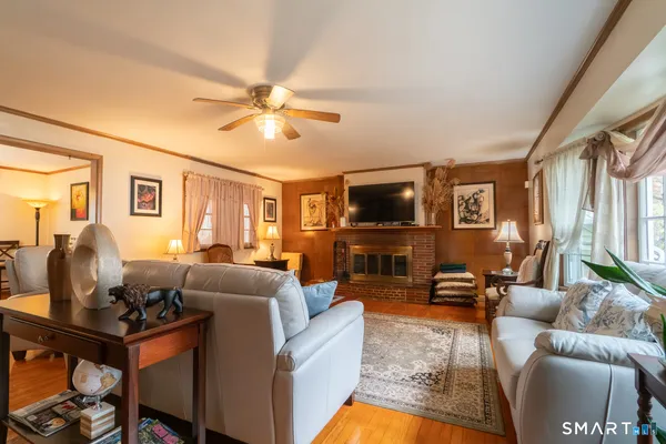 a living room with furniture a fireplace and a flat screen tv