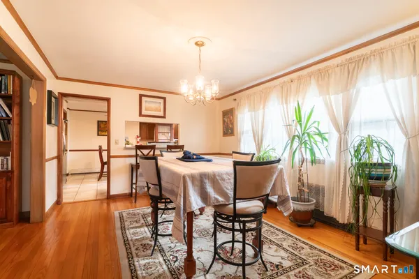 a view of a dining room with furniture window and wooden floor