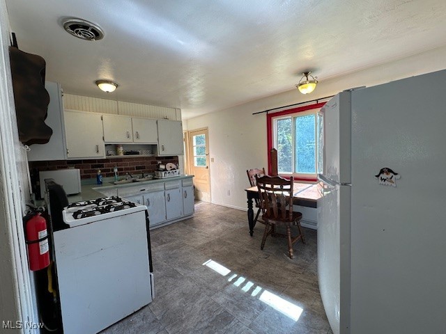 3216 South Ridge Road West Ashtabula, OH 44004 - Photo 7 of 17 Kitchen featuring white appliances and white cabinetry