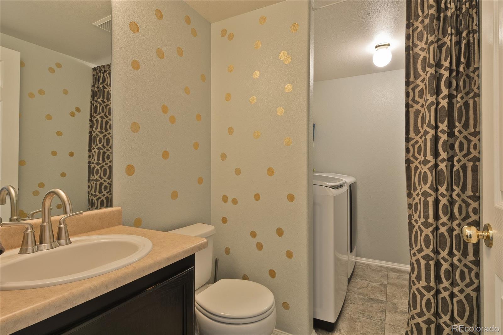 1165 Timbervale Trail Highlands Ranch, CO 80129 - Photo 13 of 29 a bathroom with a sink a toilet and shower