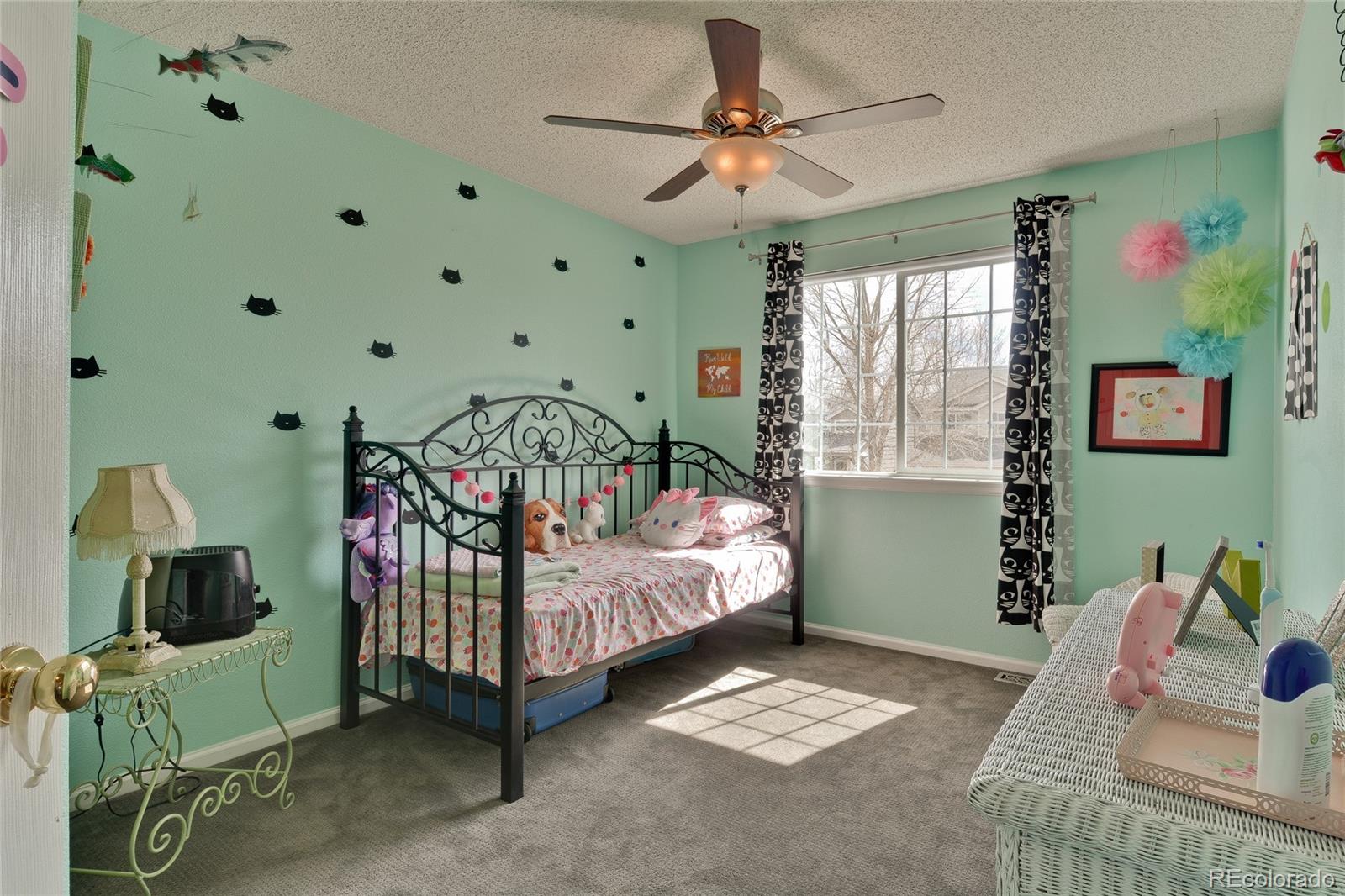 1165 Timbervale Trail Highlands Ranch, CO 80129 - Photo 19 of 29 a bedroom with furniture and a window