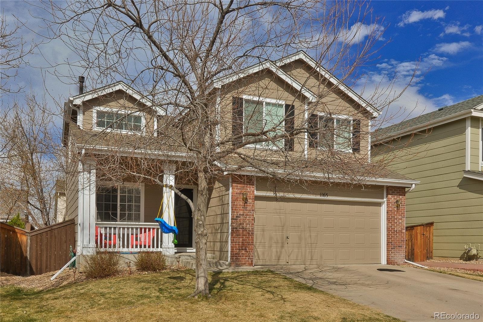 1165 Timbervale Trail Highlands Ranch, CO 80129 - Photo 2 of 29 a front view of a house with a yard