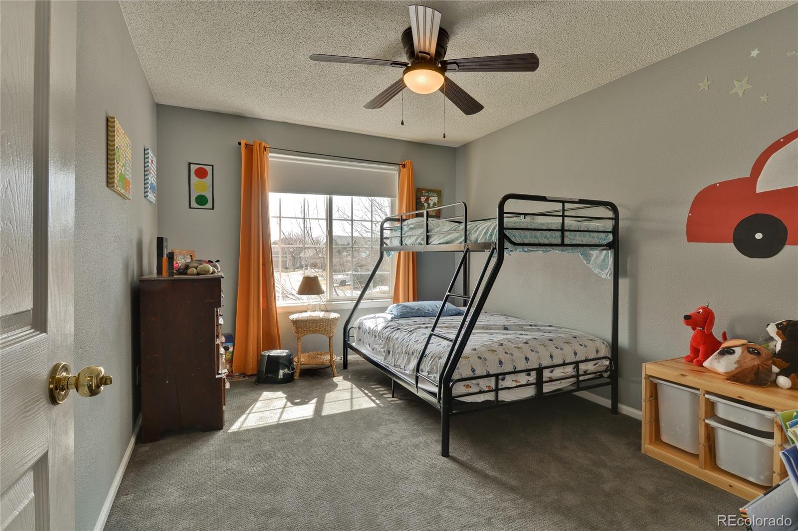 1165 Timbervale Trail Highlands Ranch, CO 80129 - Photo 21 of 29 a bedroom with a bed and a chandelier