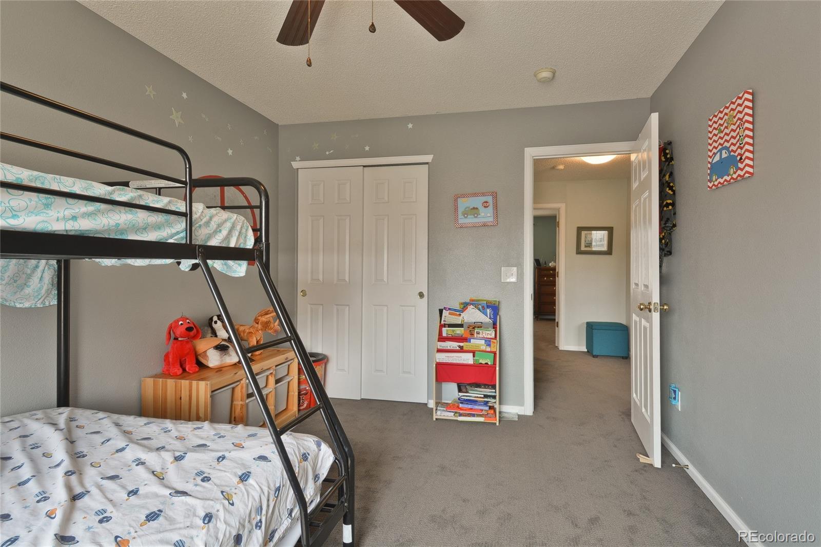 1165 Timbervale Trail Highlands Ranch, CO 80129 - Photo 22 of 29 a bedroom with a bed and a couch
