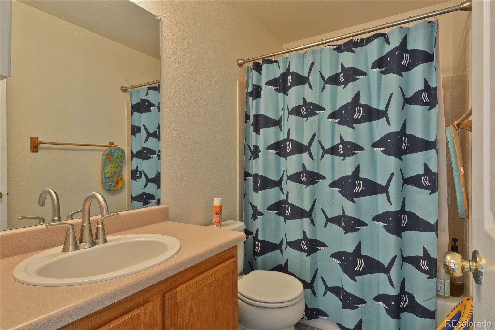 1165 Timbervale Trail Highlands Ranch, CO 80129 - Photo 23 of 29 a bathroom with a sink toilet and shower