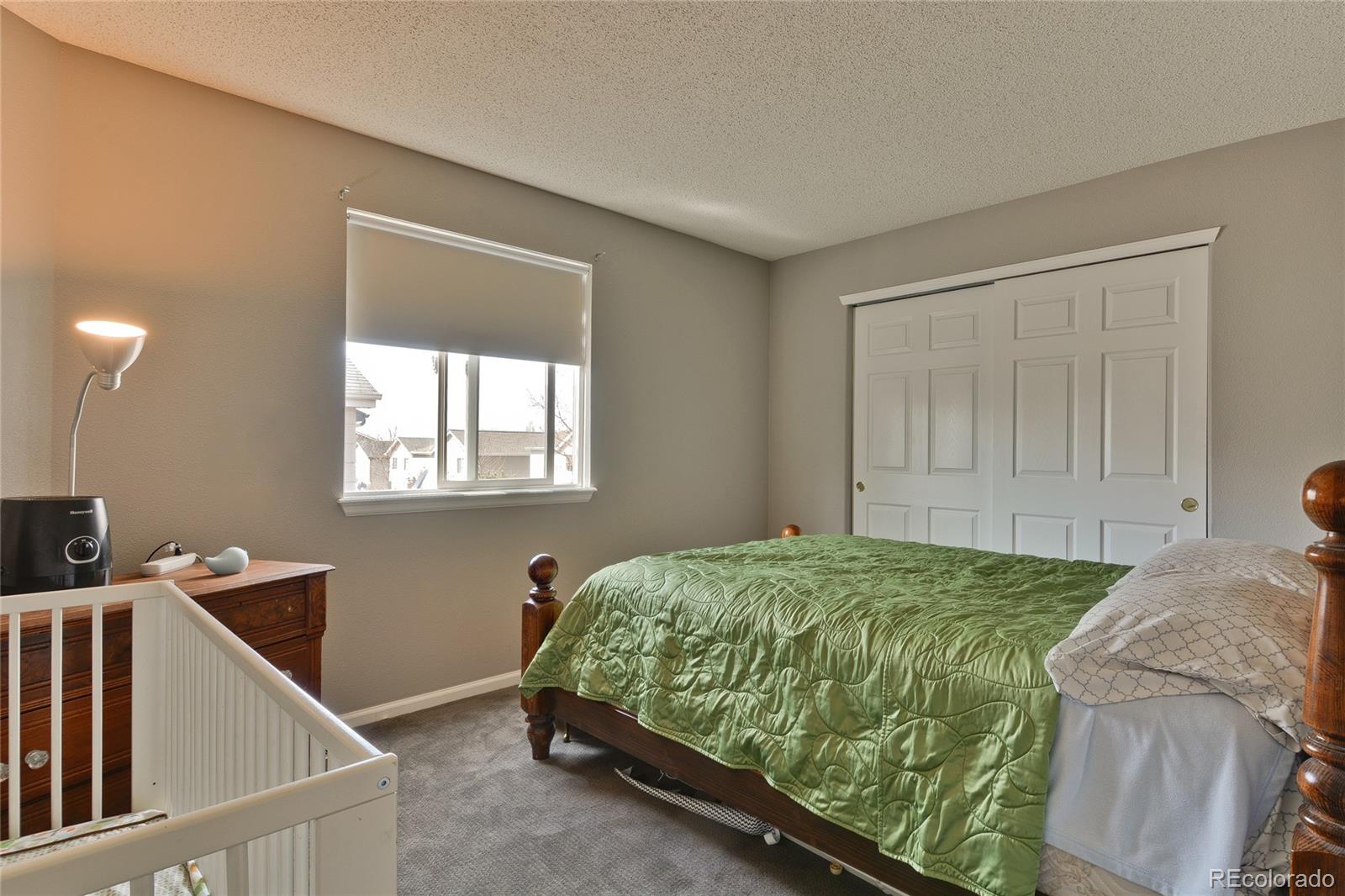 1165 Timbervale Trail Highlands Ranch, CO 80129 - Photo 24 of 29 a bedroom with a bed and a window
