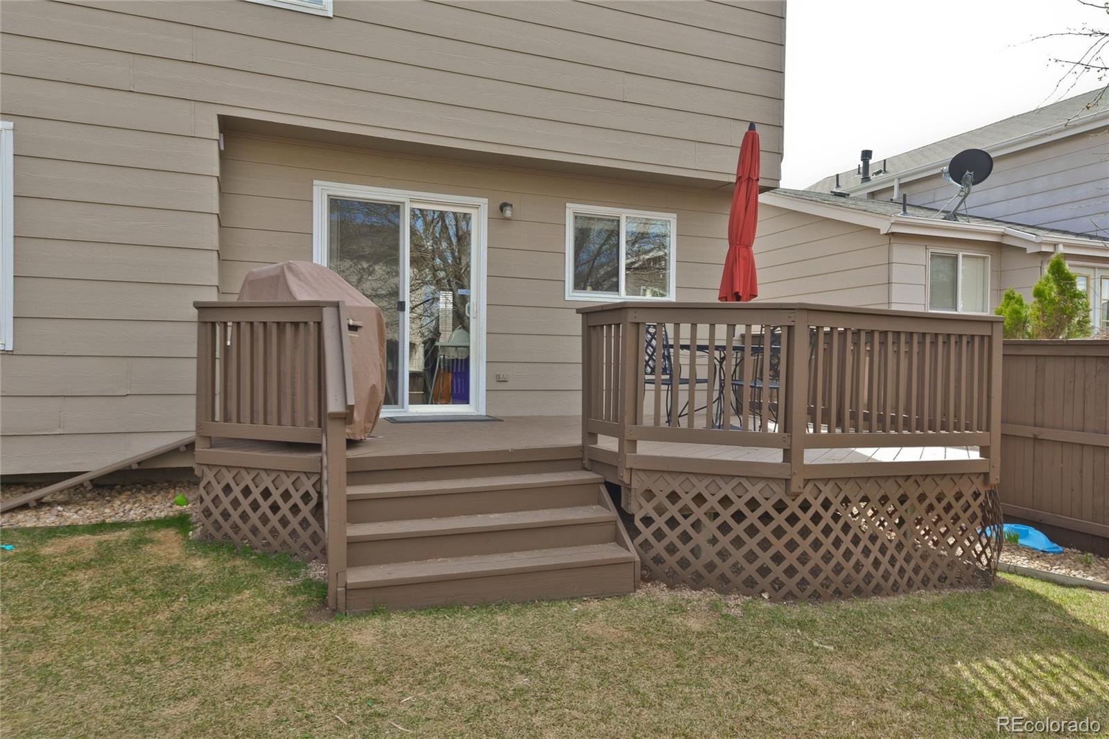 1165 Timbervale Trail Highlands Ranch, CO 80129 - Photo 28 of 29 a view of deck with chair and wooden fence