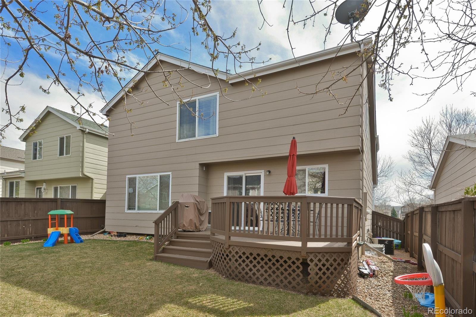 1165 Timbervale Trail Highlands Ranch, CO 80129 - Photo 29 of 29 a view of a deck with couches table and chairs and wooden fence