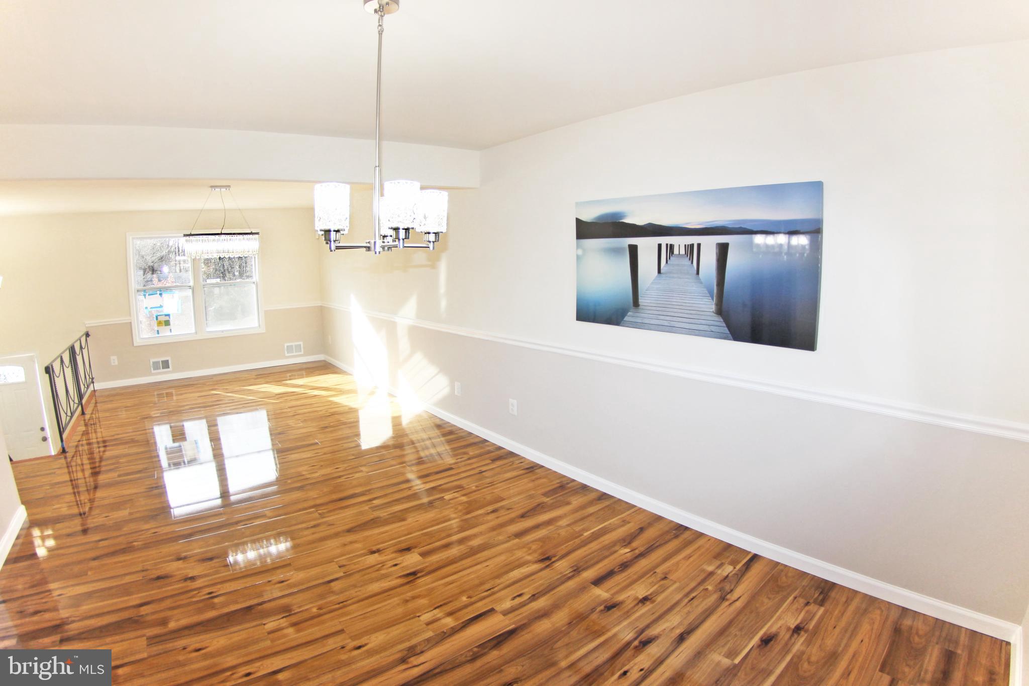 8916 Goldfield Place Clinton, MD 20735 - Photo 12 of 24 a view of empty room with wooden floor and window