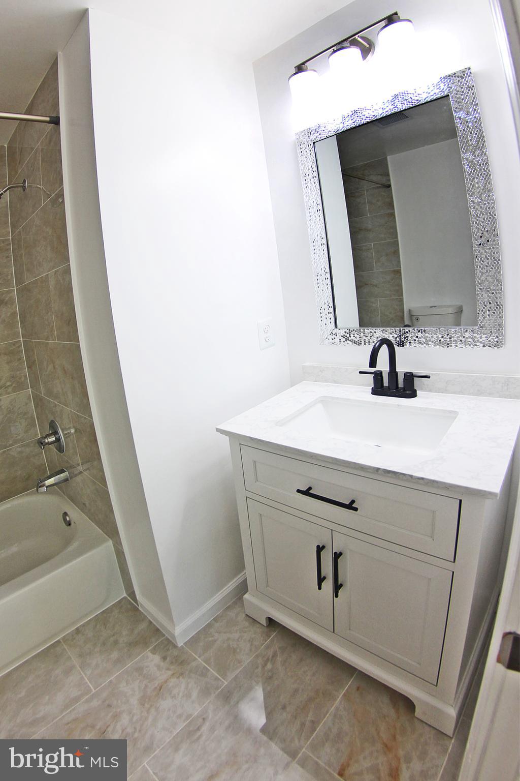 8916 Goldfield Place Clinton, MD 20735 - Photo 13 of 24 a bathroom with a sink and a mirror