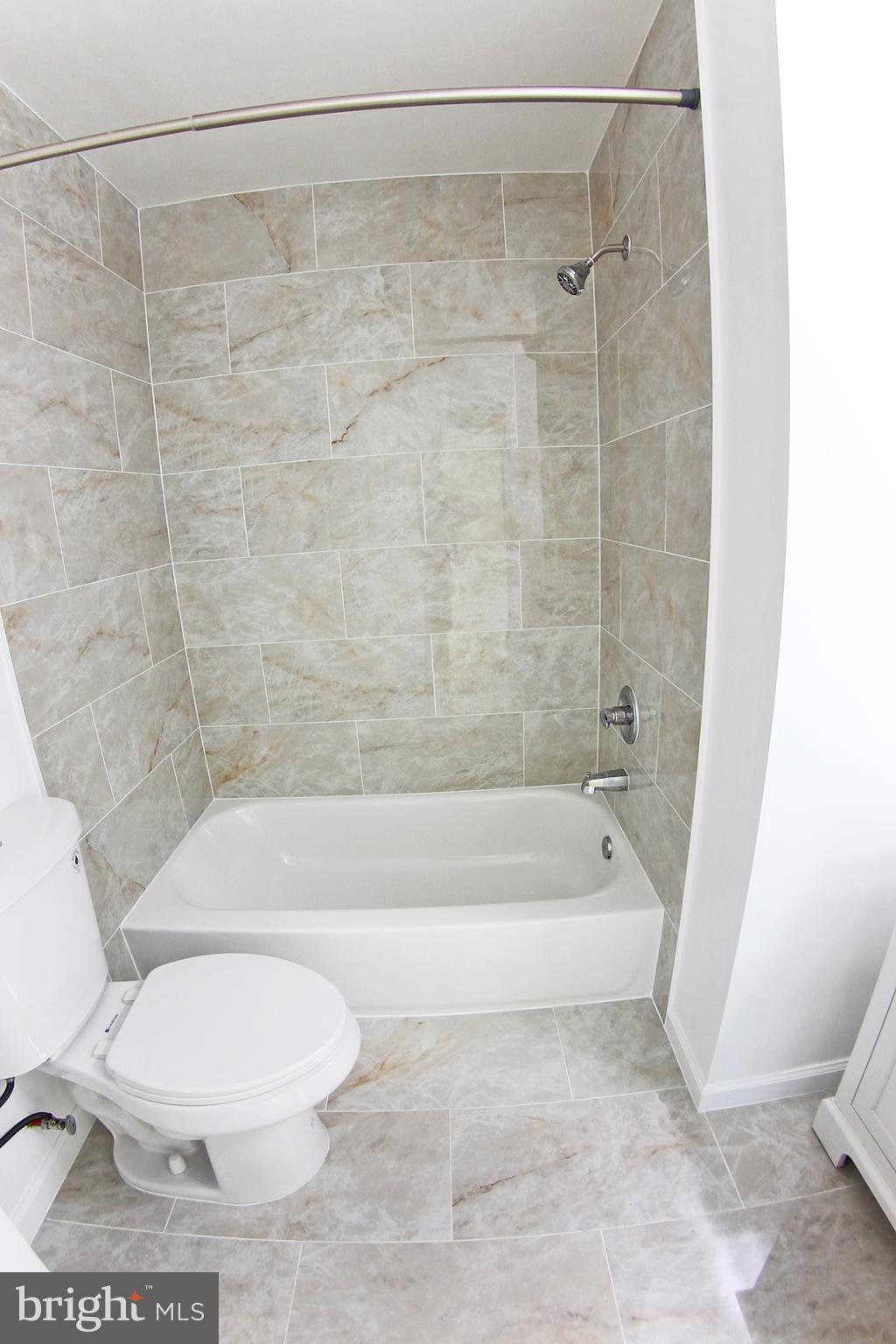 8916 Goldfield Place Clinton, MD 20735 - Photo 15 of 24 a bathroom with a toilet and a bath tub