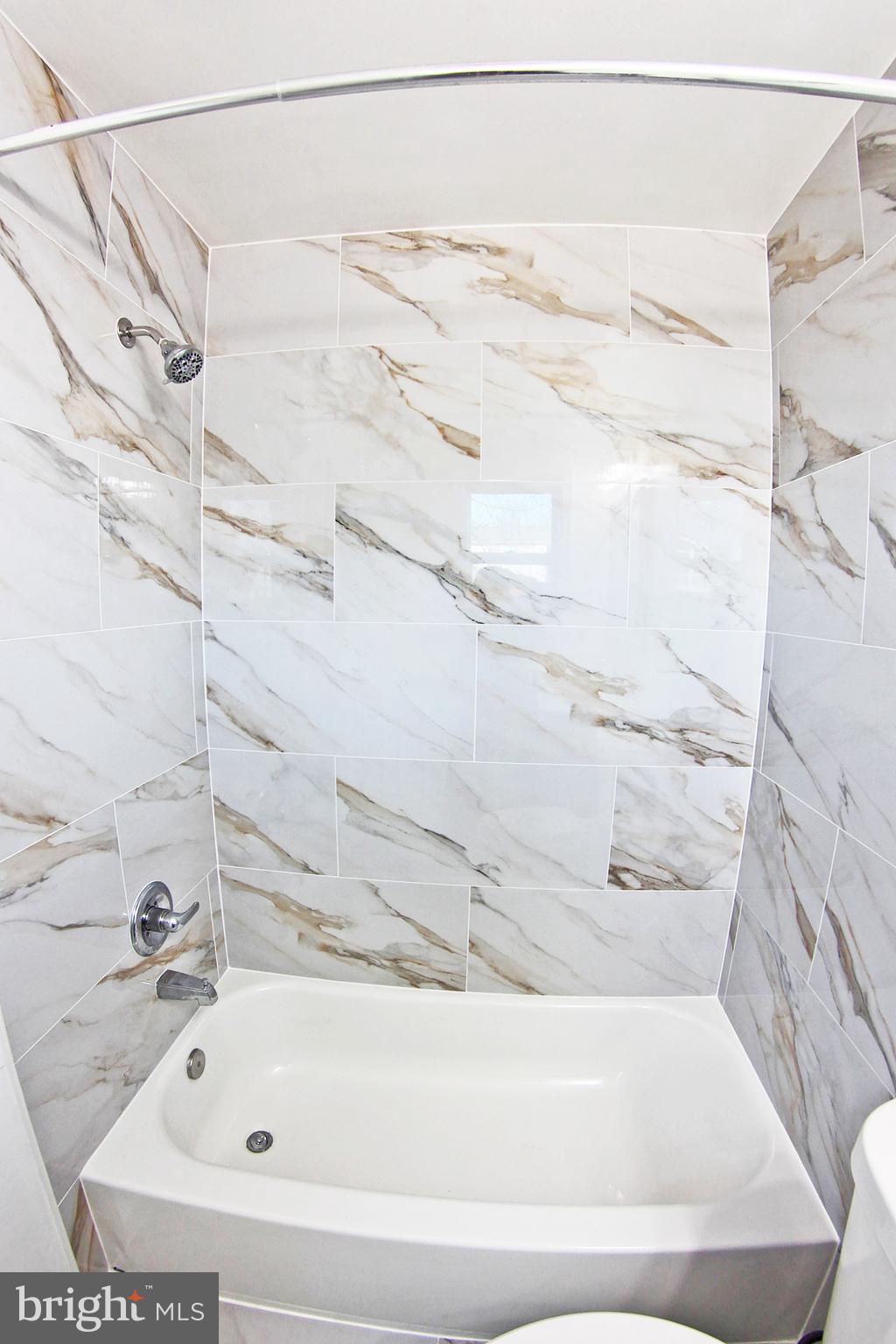 8916 Goldfield Place Clinton, MD 20735 - Photo 18 of 24 a bathroom with a bathtub and shower