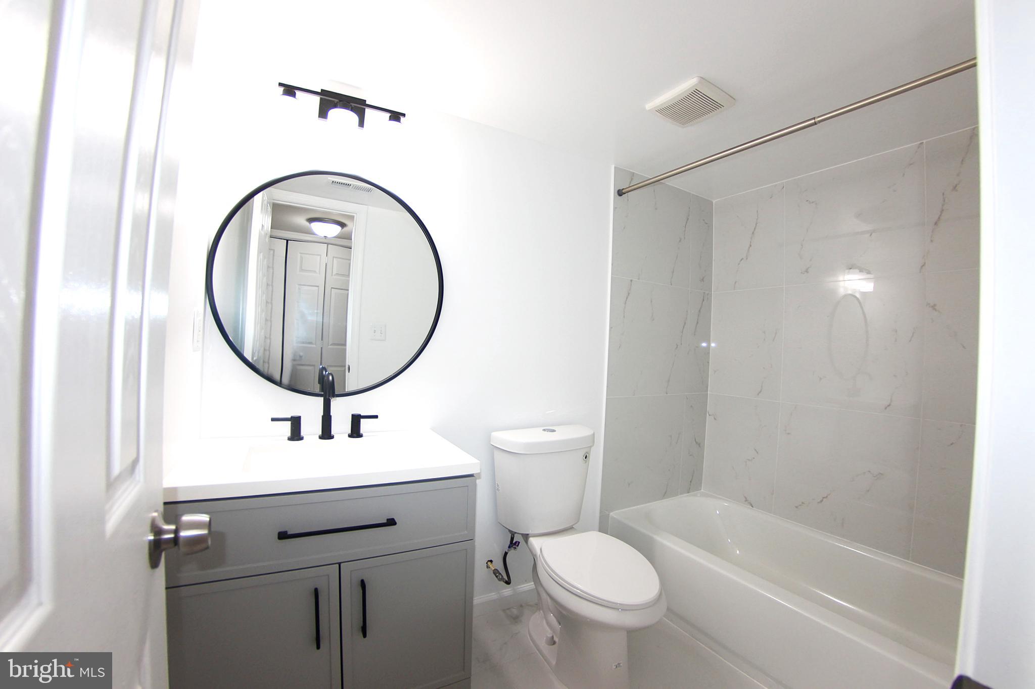 8916 Goldfield Place Clinton, MD 20735 - Photo 21 of 24 a bathroom with a sink a toilet and a mirror