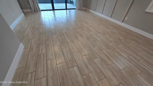 a view of a room with wooden floor