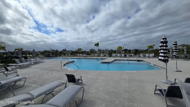 a view of swimming pool with outdoor seating