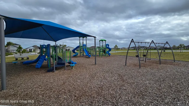 a view of outdoor space with playground and green space