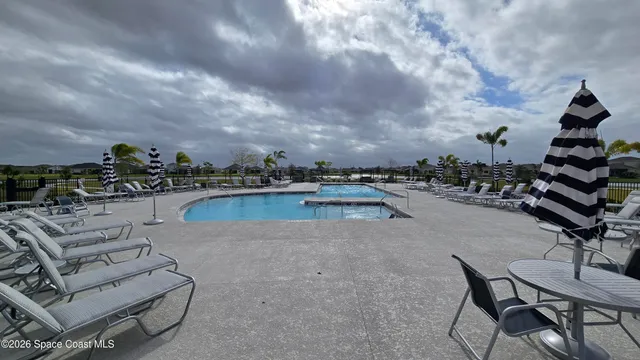 a view of a swimming pool and lounge chairs