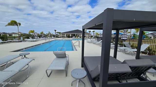 a view of a patio with table and chairs