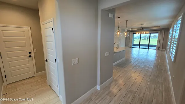 a view of hallway with wooden floor