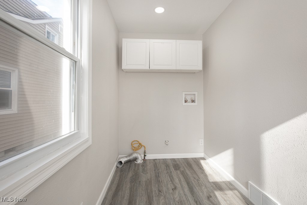 223 Beck Road Avon Lake, OH 44012 - Photo 13 of 29 Laundry room featuring hookup for a washing machine, wood finished floors, cabinet space, baseboards, and visible vents