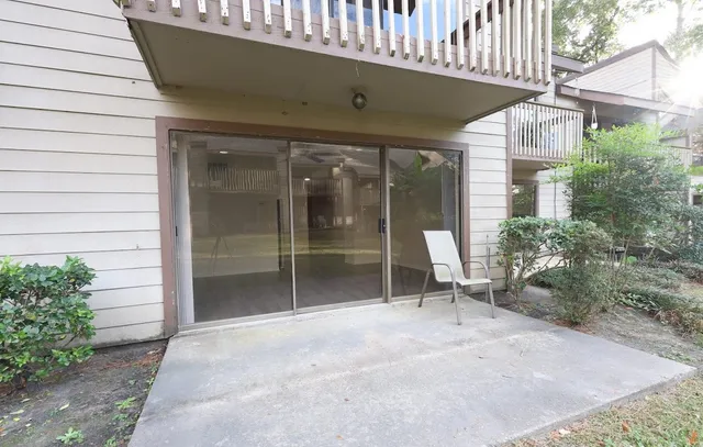a view of a chair and table in front of house