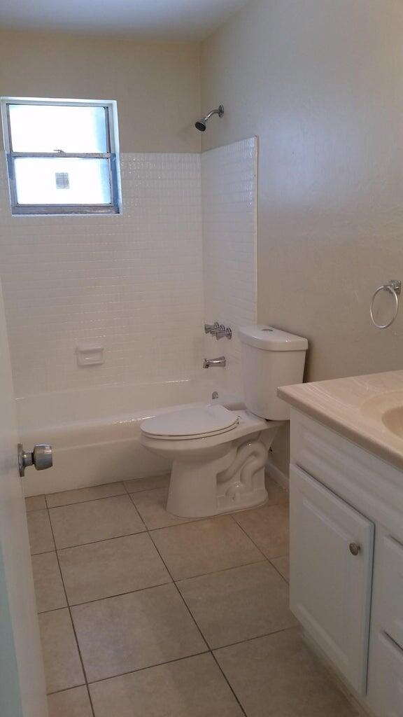 1230 West 23rd Street Riviera Beach, FL 33404 - Photo 15 of 19 a bathroom with a sink a toilet and mirror